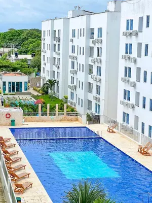 a pool in the middle of two apartment buildings at Acogedor apto en Coveñas 204 in Coveñas