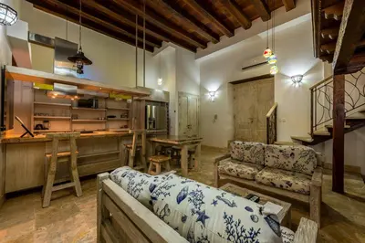 a living room with a couch and a bar at Apartamento Virrey in Cartagena de Indias