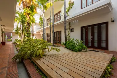 a courtyard of a building with trees and plants at Apartamento Virrey in Cartagena de Indias