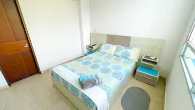 a small bedroom with a bed and a window at Hermoso Apartamento Frente al Mar 3 Habitaciones MSC34 in Estación El Salto