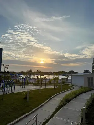 a sunset over the ocean and a road at 2BR 2BA Apt Baia Kristal Cartagena Crystal Lagoon in Cartagena de Indias