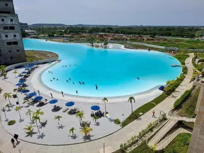 an overhead view of a large pool with blue water at 2BR 2BA Apt Baia Kristal Cartagena Crystal Lagoon in Cartagena de Indias