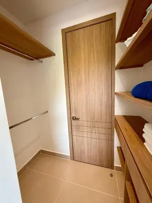 a closet with a wooden door in a room at 2BR 2BA Apt Baia Kristal Cartagena Crystal Lagoon in Cartagena de Indias