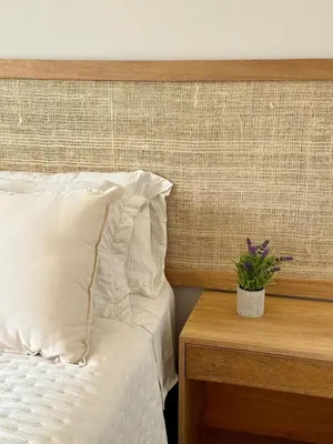 a bedroom with a bed and a table with a potted plant at 2BR 2BA Apt Baia Kristal Cartagena Crystal Lagoon in Cartagena de Indias