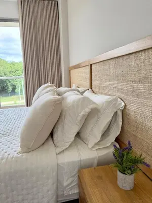 a bedroom with a bed with white pillows at 2BR 2BA Apt Baia Kristal Cartagena Crystal Lagoon in Cartagena de Indias