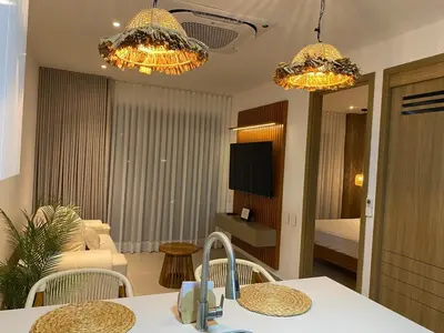 a kitchen with two chandeliers and a living room at Vista a la laguna - Baia Kristal in Los Arrayanes