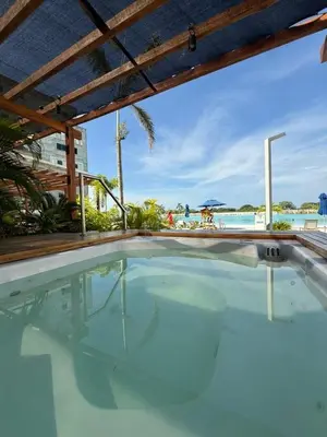 an indoor swimming pool with a view of the ocean at Vista a la laguna - Baia Kristal in Los Arrayanes