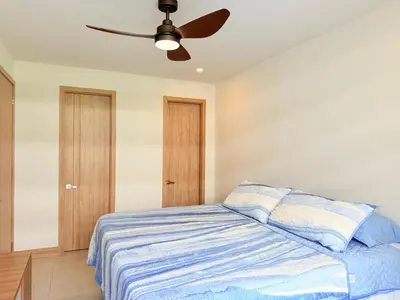 a bedroom with a bed with a ceiling fan at Shoreline Escape - Private Pool - Beach in Cartagena de Indias
