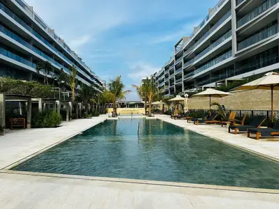 a swimming pool in front of a large building at Shoreline Escape - Private Pool - Beach in Cartagena de Indias