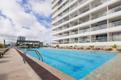 a swimming pool in front of a building at Cartagena Beach By Belong in Cartagena de Indias