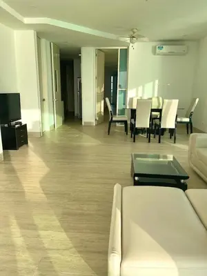 a living room with a couch and a table and chairs at Apartamento frente al mar in Coveñitas
