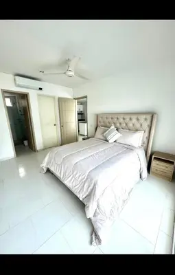 a white bedroom with a large bed in it at Modern and comfortable in Cartagena de Indias