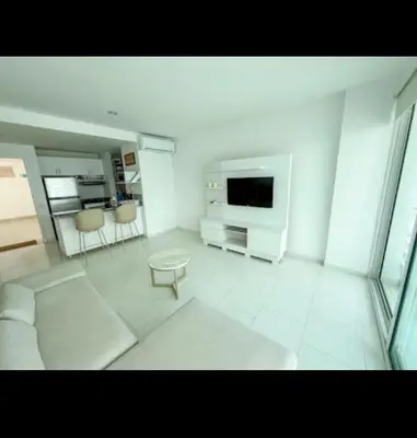 a white living room with a tv and a couch at Modern and comfortable in Cartagena de Indias