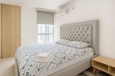 a bedroom with a bed and a window at Beach Veronica Luxury Ocean View Apartment in Cartagena de Indias