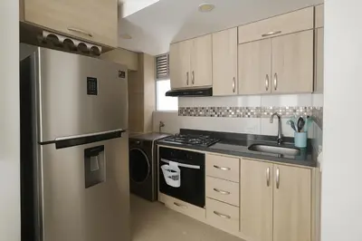 a kitchen with a refrigerator and a sink at Beach Veronica Luxury Ocean View Apartment in Cartagena de Indias