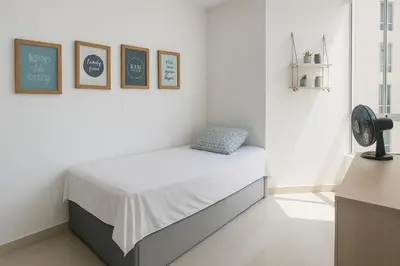 a bedroom with a bed in a white room at Beach Veronica Luxury Ocean View Apartment in Cartagena de Indias