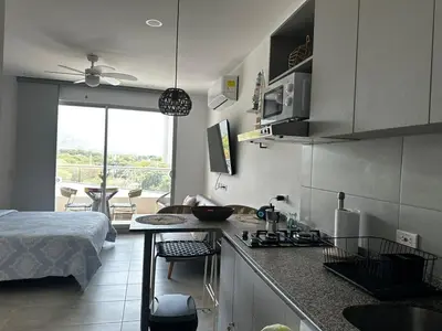 a kitchen with a bed and a table in a room at New luxury studio apartment with ocean view, Santa Marta in Simón Bolivar