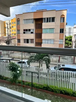 a white picket fence in front of a building at Moderno Rincón Urbano in Cartagena de Indias