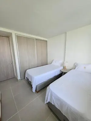 a hotel room with two beds and a window at Estilo y confort en cartagena, a pasos del mar in Cartagena de Indias