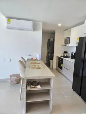a kitchen with a island in the middle of a room at Estilo y confort en cartagena, a pasos del mar in Cartagena de Indias