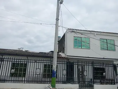 a white building with a pole in front of it at Cartagena brisa y caracol in Cartagena de Indias