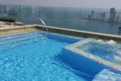 a swimming pool with blue water in a building at Ocean view apartment in Cartagena de Indias