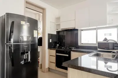 a kitchen with a stainless steel refrigerator and a sink at Ocean view apartment in Cartagena de Indias