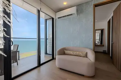a living room with a white couch and glass doors at New Murano Centro/Near Walled City/Panoramic Pool in Cartagena de Indias
