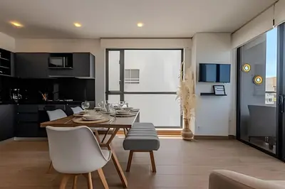 a kitchen and dining room with a table and chairs at New Murano Centro/Near Walled City/Panoramic Pool in Cartagena de Indias