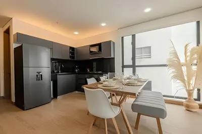 a kitchen and dining room with a table and chairs at New Murano Centro/Near Walled City/Panoramic Pool in Cartagena de Indias