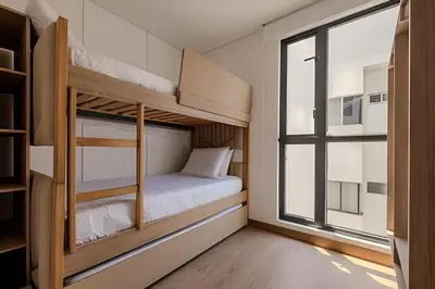 a small bedroom with bunk beds and a window at New Murano Centro/Near Walled City/Panoramic Pool in Cartagena de Indias
