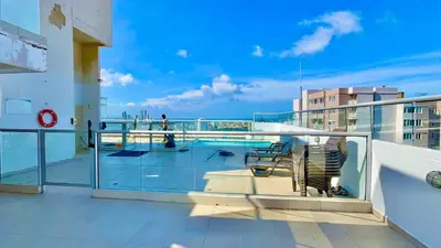 a balcony with a view of a pool on a building at Apartamento en Cartagena cerca al mar in Cartagena de Indias