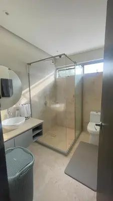 a bathroom with a shower and a toilet and a sink at Cabaña privada con piscina y jacuzzi junto al mar in Santa Veronica