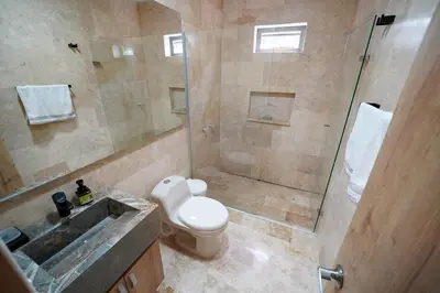 a bathroom with a shower and a toilet and a sink at Casa Juliana vista al mar piscina y jacuzzi in Tubará