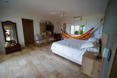 a bedroom with a bed with a hammock in it at Casa Juliana vista al mar piscina y jacuzzi in Tubará