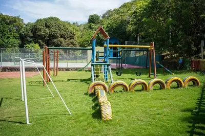 a park with a playground with a slide at Casa Juliana vista al mar piscina y jacuzzi in Tubará