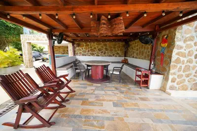 a patio with chairs and a table on a patio at Casa Juliana vista al mar piscina y jacuzzi in Tubará