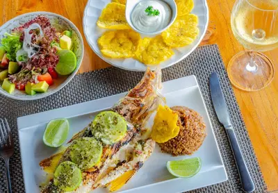 a plate of food with a fish on a table at Casa Pizarro Hotel Boutique in Cartagena de Indias