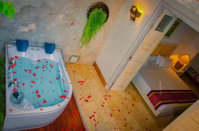a bathroom with a tub in a room with a bed at Casa Pizarro Hotel Boutique in Cartagena de Indias