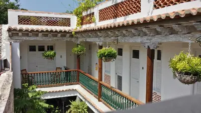 a house with a balcony with potted plants at Casa Pizarro Hotel Boutique in Cartagena de Indias