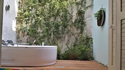 a bath tub sitting in front of a wall at Casa Pizarro Hotel Boutique in Cartagena de Indias