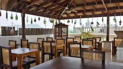 a dining room with wooden tables and chairs at Casa Pizarro Hotel Boutique in Cartagena de Indias