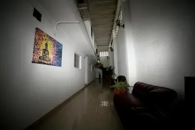 a hallway with a couch and a painting on the wall at Hotel San Marcos Barranquilla in Barranquilla