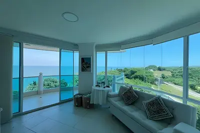 a living room with a couch and views of the ocean at Apartamento de playa privada in Santa Marta