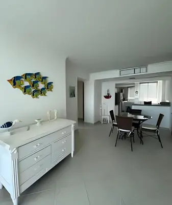a white kitchen and dining room with a table and chairs at Apartamento de playa privada in Santa Marta