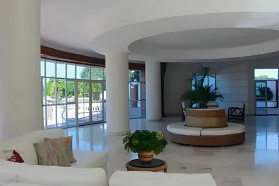 a living room with white couches and potted plants at Alojamiento exclusivo frente al mar in Santa Marta