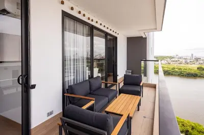 a living room with chairs and a balcony with a view at Loft cercano al Centro Histórico-Cartagena in Cartagena de Indias