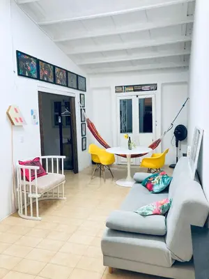 a living room with a couch and chairs and a table at Auténtico apartamento en centro histórico con arte in Cartagena de Indias