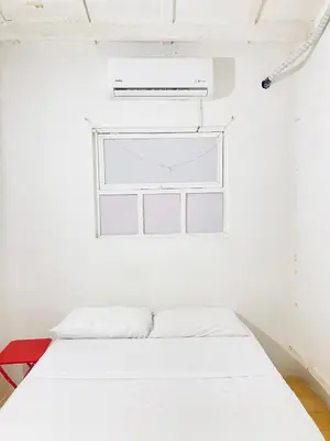 a white room with a bed and a window at Auténtico apartamento en centro histórico con arte in Cartagena de Indias