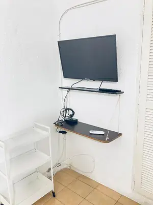 a desk with a computer monitor on a shelf at Auténtico apartamento en centro histórico con arte in Cartagena de Indias